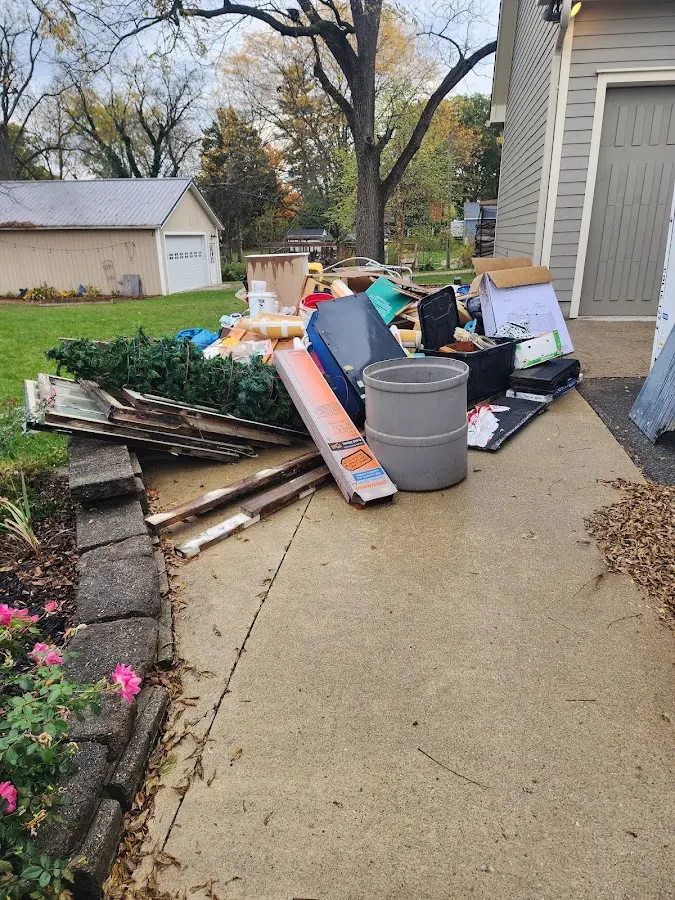 Dumpster being loaded with debris for Commercial Dumpster Rental in Powell